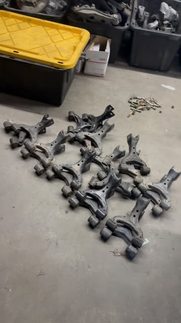 Miata suspension control arms photographed in the EMP garage